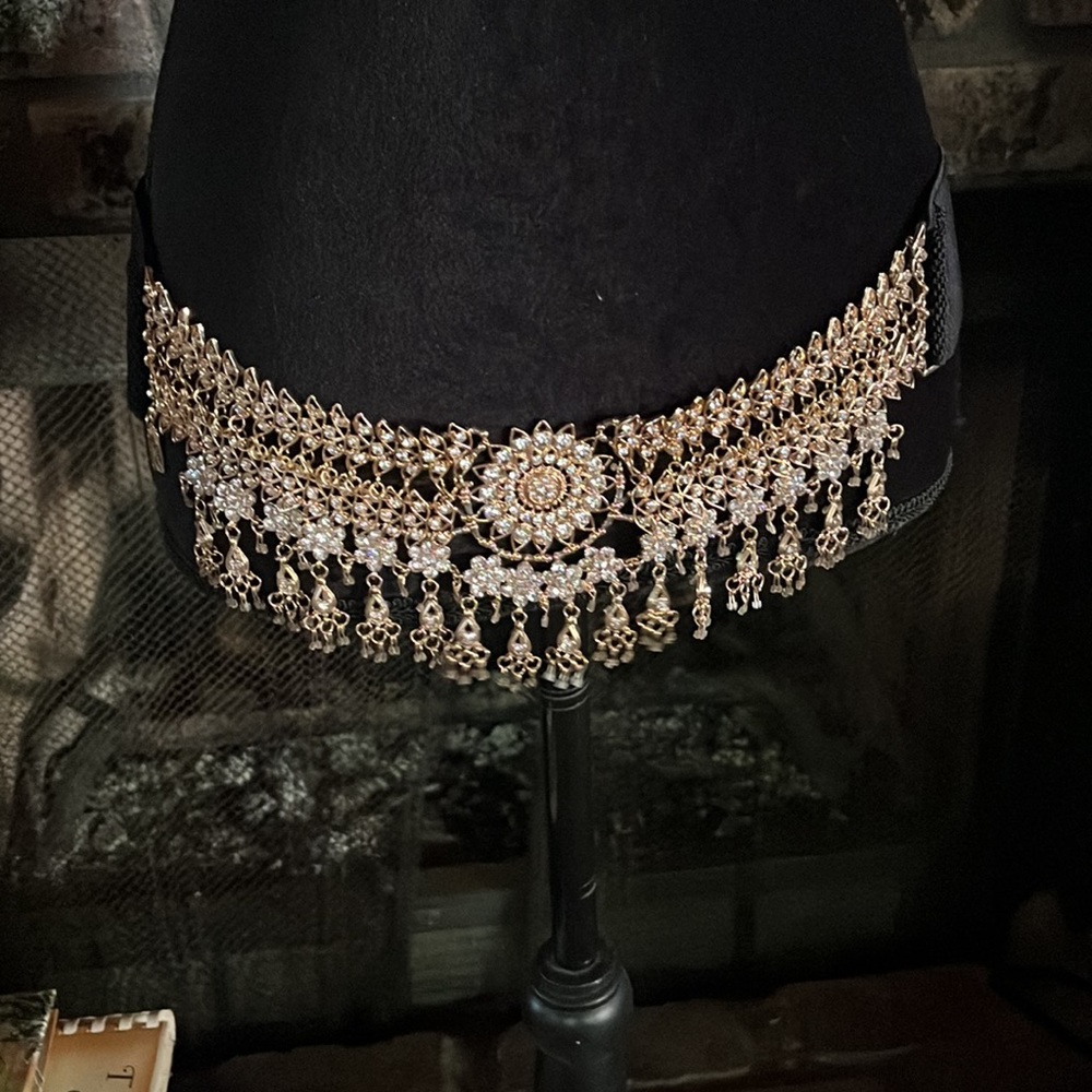 Adjustable, expandable Black and Bling Belt. Measures approximately 35”.